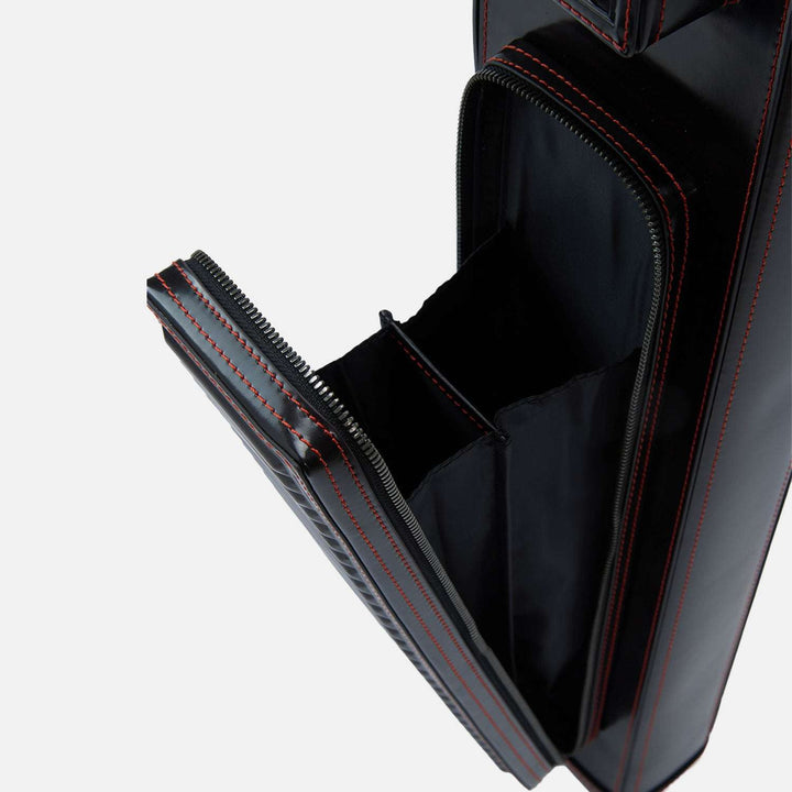 Black leather cue case with red stitching on a white background