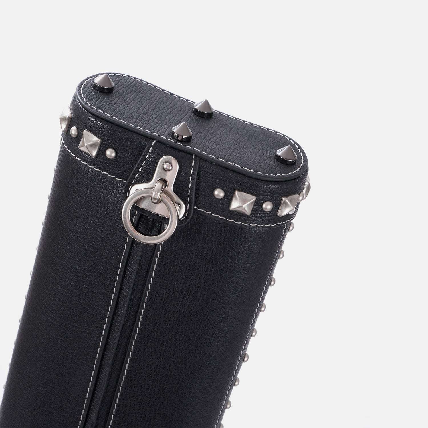 Black leather cue case with silver studs and ring on a white background