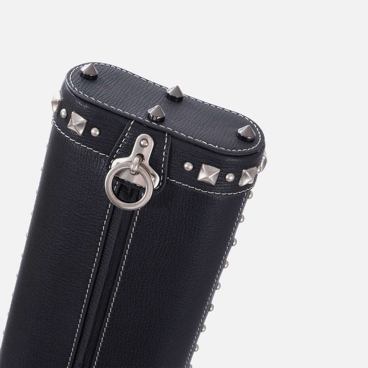 Black leather cue case with silver studs and ring on a white background