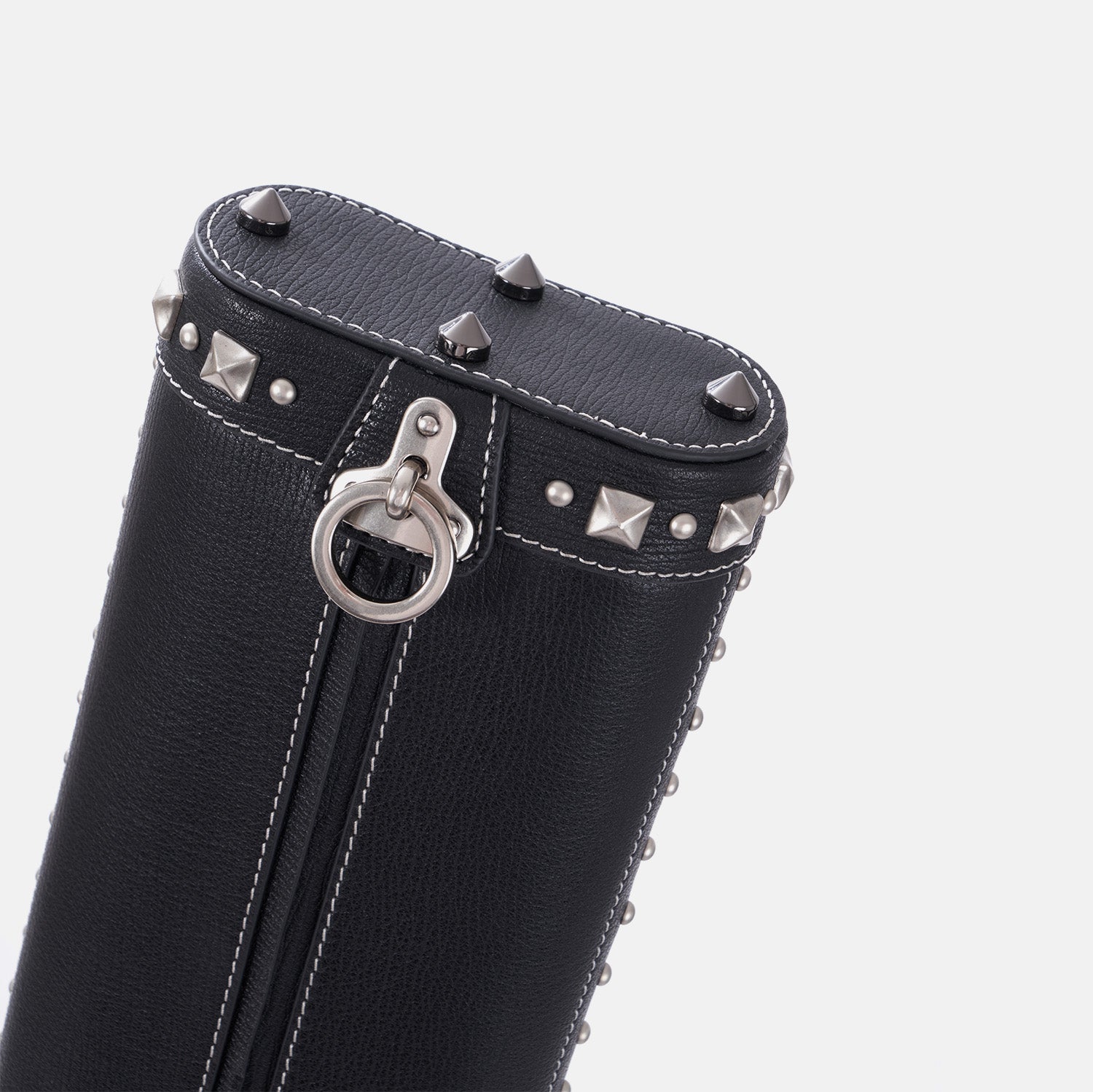 Black leather cue case with silver studs and ring on a white background