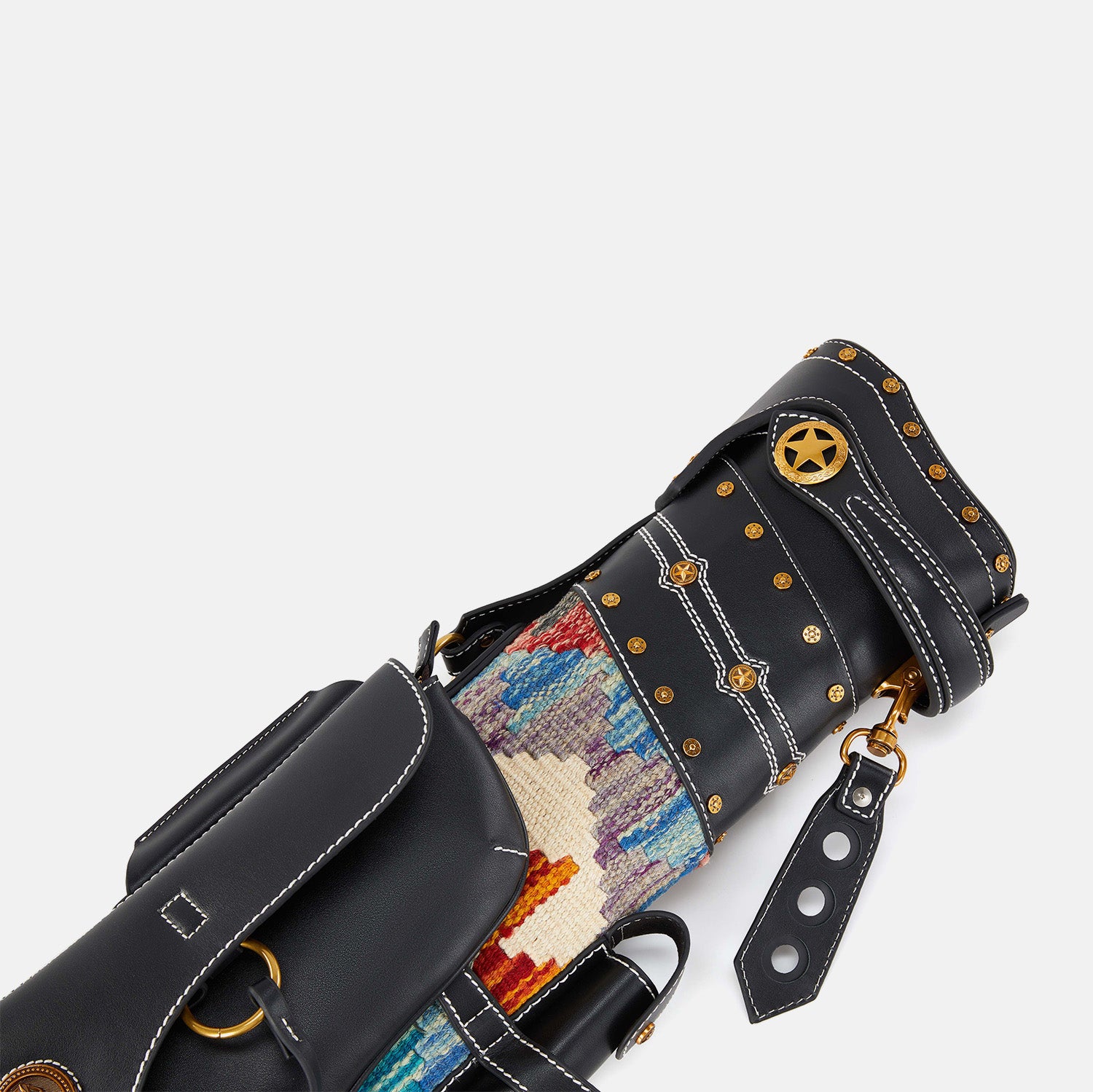 Close-up of a black cue case with colorful interior and gold studs on a white background